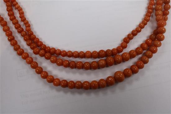 A triple strand graduated coral bead necklace, gross weight 51 grams, 50cm.